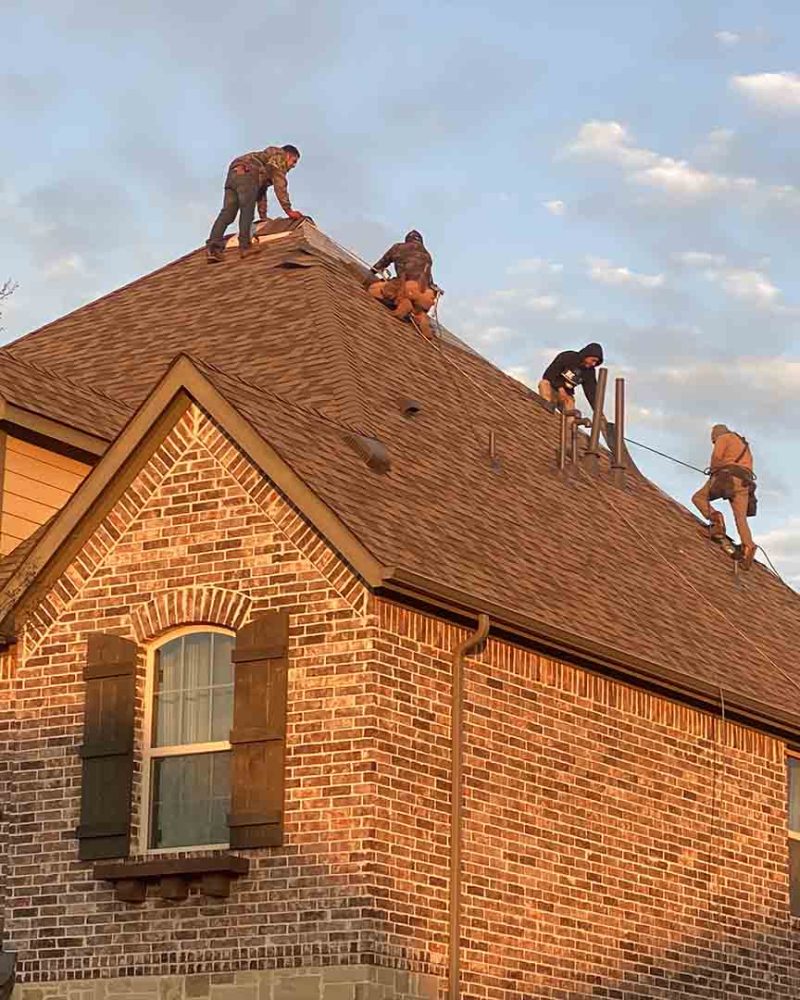 Gallery-photo-14 Roofers working on a House at Sunset